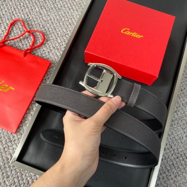 Cartier palladium plated needle buckle belt with "CARTIER" logo. Black Nile crocodile leather belt w